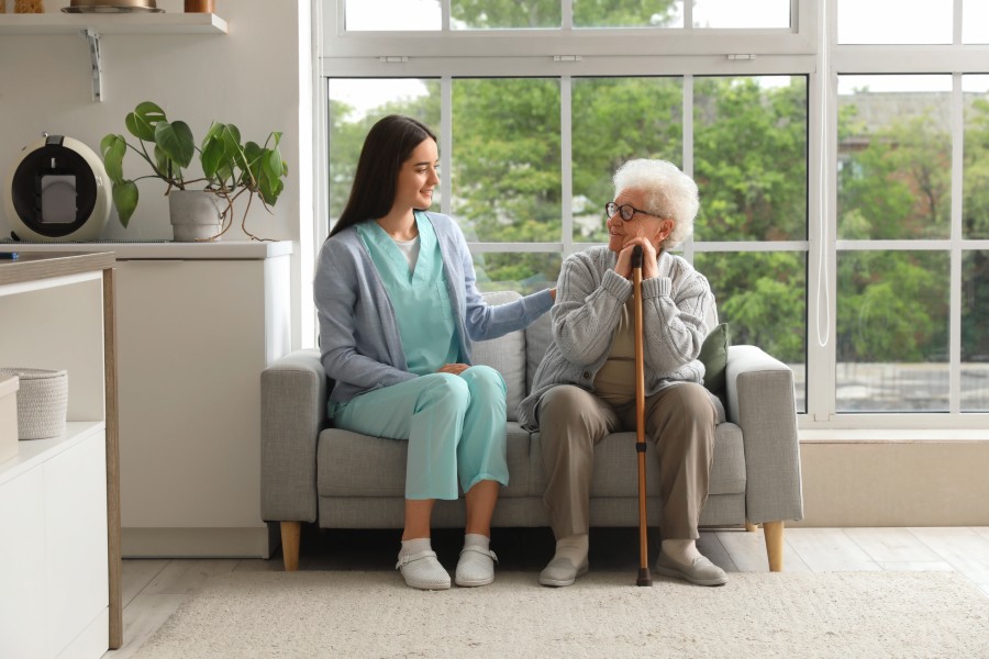 Home health aide helping patient with daily activities